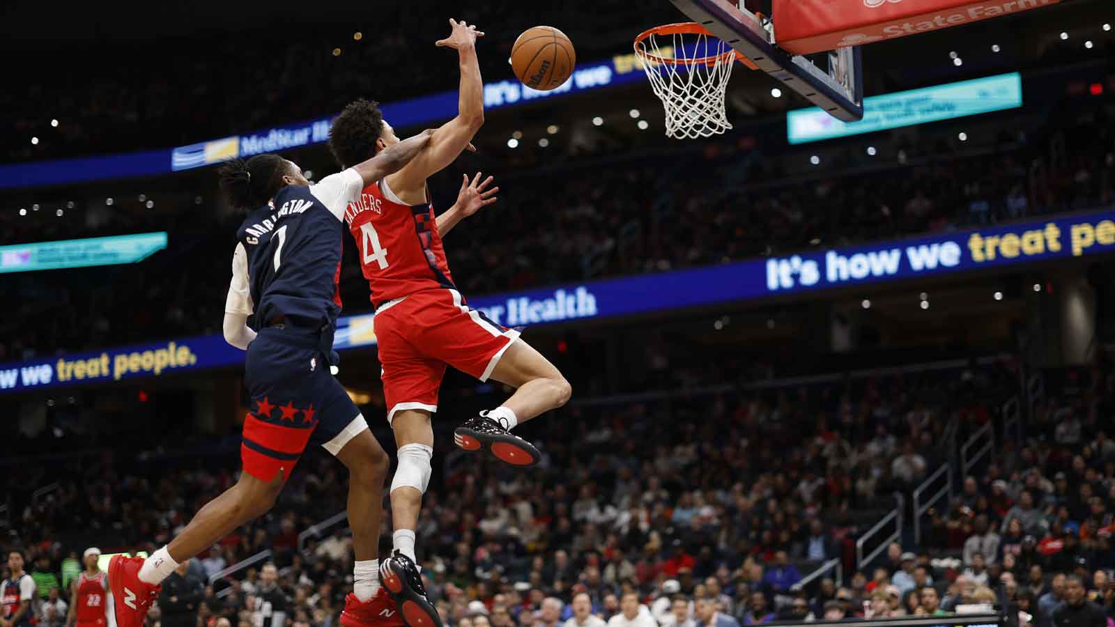 Washington Wizards guard Bub Carrington (7) blocks the shot of LA Clippers guard Kobe Sanders (4) in the second half at Capital One Arena.