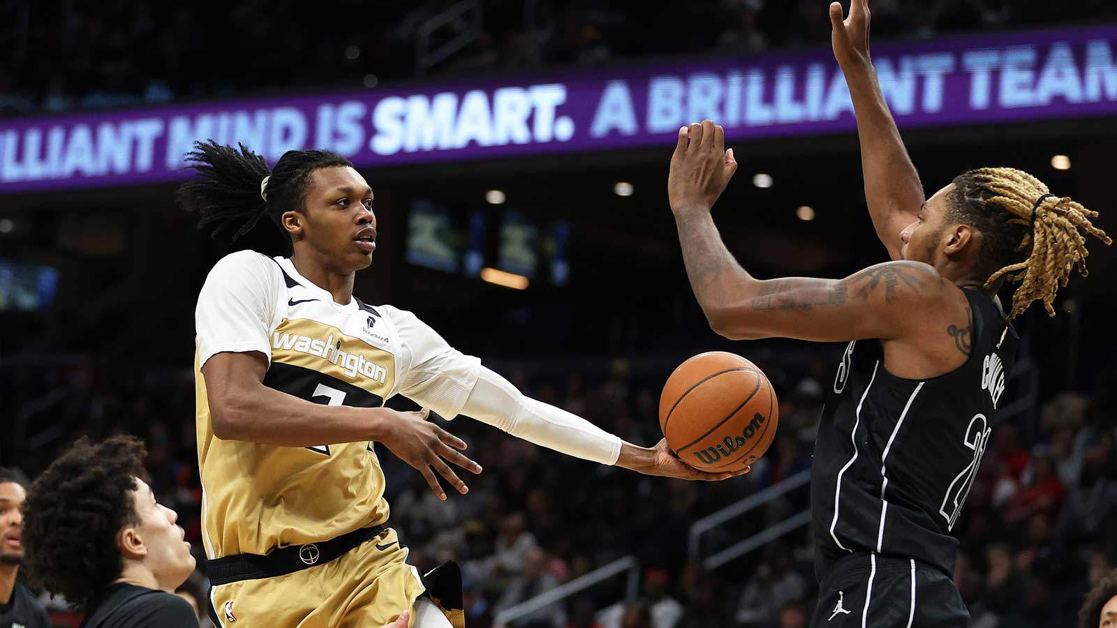 Washington Wizards guard Bub Carrington (7) passes the ball past Brooklyn Nets forward Noah Clowney (21) during the second half at Capital One Arena. 