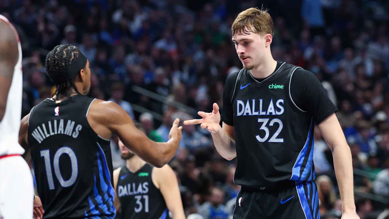 Dallas Mavericks guard Brandon Williams (10) celebrates with Dallas Mavericks forward Cooper Flagg (32) during the second half against the Houston Rockets at American Airlines Center.