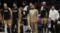 Newly acquired Washington Wizards guard Trae Young (M) looks on from the bench with teammates against the New Orleans Pelicans in the first half at Capital One Arena.