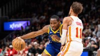 Golden State Warriors forward Jonathan Kuminga (00) drives the ball against Atlanta Hawks guard Trae Young (11) during the third quarter at State Farm Arena