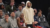 Washington Wizards guard Trae Young (3) (white hoodie) looks on from the bench in the second half against the Los Angeles Clippers at Intuit Dome.