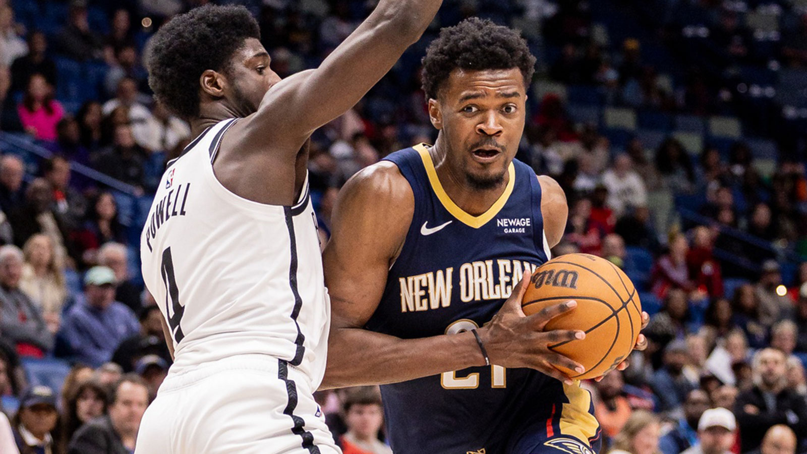 New Orleans Pelicans center Yves Missi (21) dribbles against Brooklyn Nets guard/forward Drake Powell (4) during the second half at Smoothie King Center.