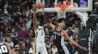 San Antonio Spurs forward Victor Wembanyama (1) blocks a shot by New Orleans Pelicans center Yves Missi (21) in the first half at Frost Bank Center.