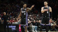 Feb 6, 2025; Portland, Oregon, USA; Sacramento Kings guard Malik Monk (0) and guard Zach LaVine (8) talk during a break in the action against the Portland Trail Blazers at Moda Center. Mandatory Credit: Troy Wayrynen-Imagn Images