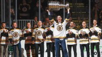 In ceremonies honoring the 100th season of the Boston Bruins, former captain Zdeno Chara raises the Stanley Cup as teammates from their 2011 championship team look on before the game between the Boston Bruins and the Toronto Maple Leafs at TD Garden.