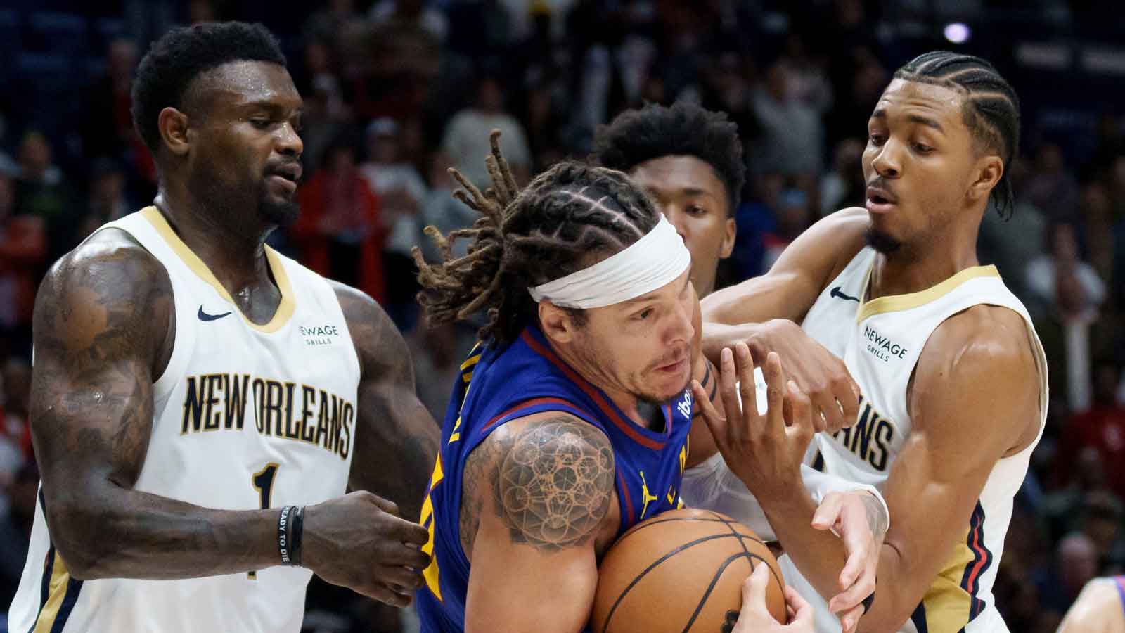 Denver Nuggets forward Aaron Gordon (32) grabs a rebound away from New Orleans Pelicans forward Zion Williamson (1) and forward Trey Murphy III (25) during the second half at Smoothie King Center. 