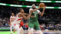 Dallas Mavericks forward Anthony Davis (3) passes the ball past Toronto Raptors guard Ochai Agbaji (30) during the game between the Mavericks and the Raptors at the American Airlines Center.