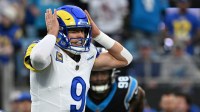 Los Angeles Rams quarterback Matthew Stafford (9) changes signals at the line in the first quarter in an NFC Wild Card Round game at Bank of America Stadium.