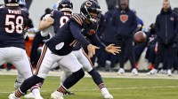 Chicago Bears quarterback Caleb Williams (18) tosses the ball against the Detroit Lions during the first half at Soldier Field.