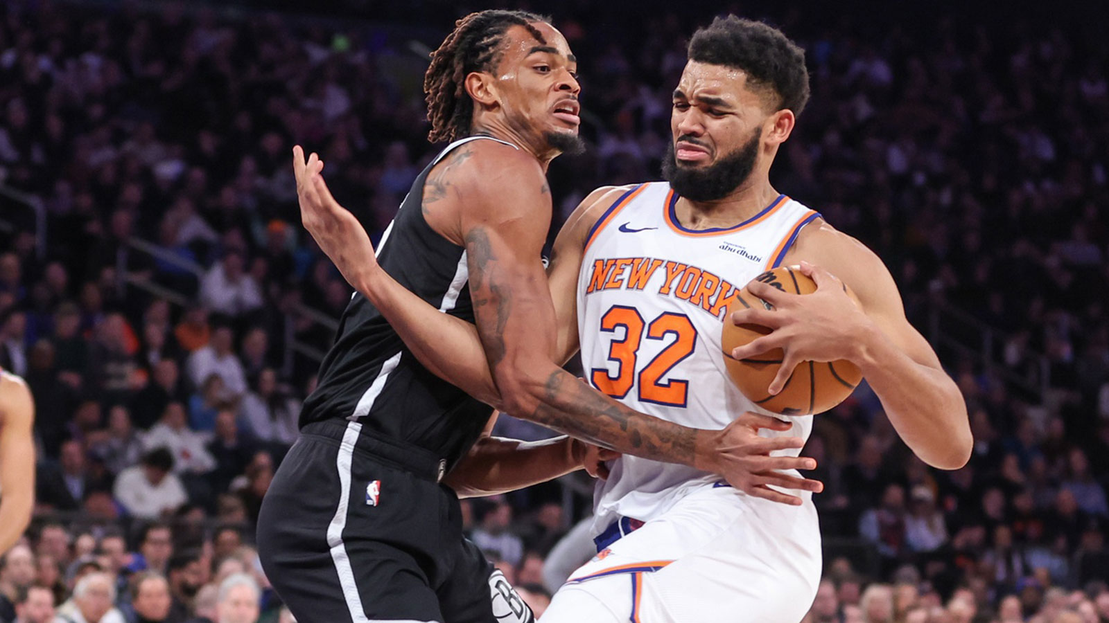 Jan 21, 2026; New York, New York, USA; New York Knicks center Karl-Anthony Towns (32) looks to drive past Brooklyn Nets center Nic Claxton (33) in the second quarter at Madison Square Garden. Mandatory Credit: Wendell Cruz-Imagn Images