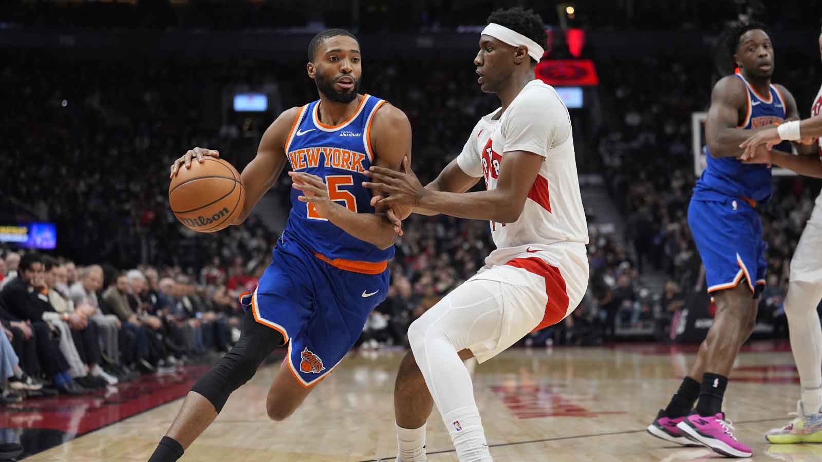 Jan 28, 2026; Toronto, Ontario, CAN; Toronto Raptors guard Ja'Kobe Walter (14) defends against New York Knicks guard Mikal Bridges (25) during the first half at Scotiabank Arena. Mandatory Credit: John E. Sokolowski-Imagn Images