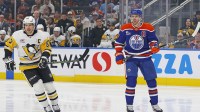 Edmonton Oilers forward Connor McDavid (97) and Pittsburgh Penguins forward Sidney Crosby (87) look for a loose puck during the first period at Rogers Place.