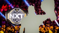 WWE NXT Championship and silhouette of Oba Femi.