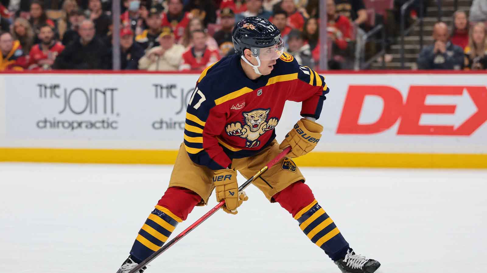 Florida Panthers center Evan Rodrigues (17) moves the puck against the Boston Bruins during the first period at Amerant Bank Arena.