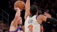 Los Angeles Lakers guard Luka Doncic (77) takes a shot against New York Knicks guard Josh Hart (3) during the third quarter at Madison Square Garden. Mandatory Credit: Brad Penner-Imagn Images