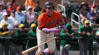 San Francisco Giants left fielder Harrison Bader (9) hits a single against the Athletics in the third inning at Scottsdale Stadium.