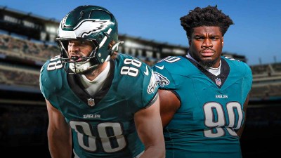 Dallas Goedert and Jordan Davis in front of the Eagles stadium.