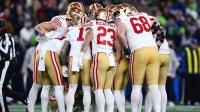 The San Francisco 49ers huddled against the Seattle Seahawks during the first half in an NFC Divisional Round game at Lumen Field.