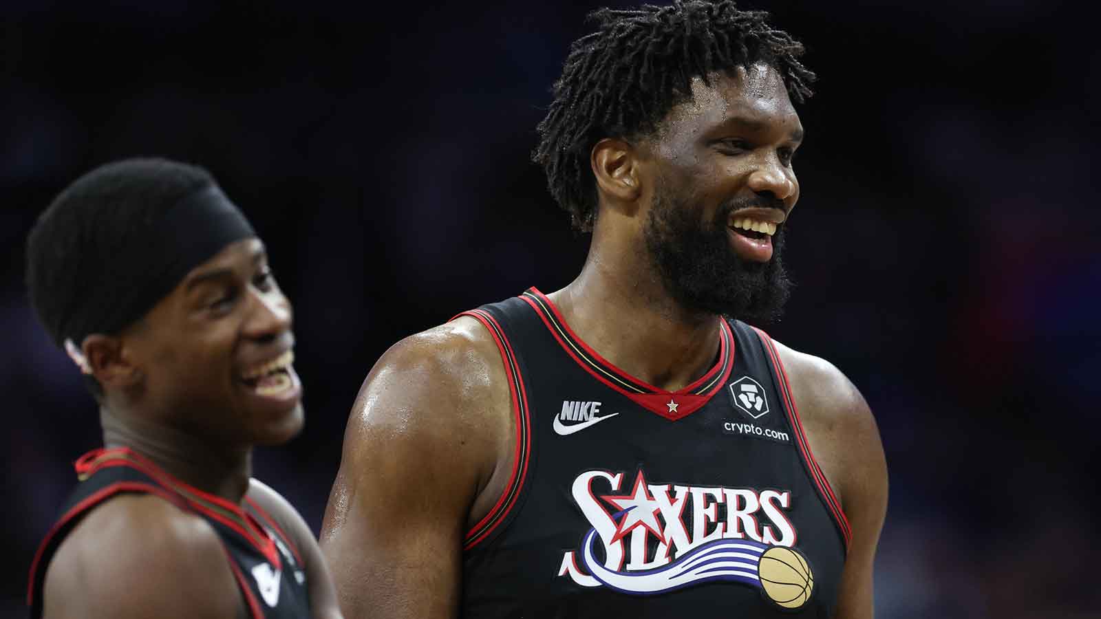76ers center Joel Embiid (21) and guard Vj Edgecombe (77) share a lighter moment during the fourth quarter against the New Orleans Pelicans at Xfinity Mobile Arena