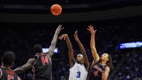 BYU Cougars forward AJ Dybantsa (3) shoots the ball against Houston Cougars forward Kalifa Sakho (14) guard Kingston Flemings (4) during the first half at Marriott Center.
