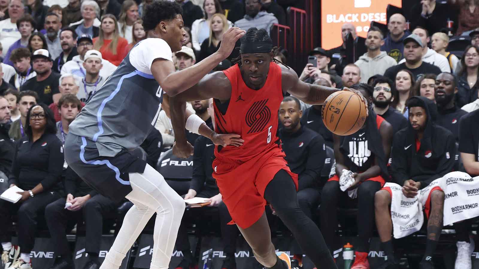 Portland Trail Blazers guard Jrue Holiday (5) drives against Utah Jazz guard Ace Bailey (19) during the first half at Delta Center.