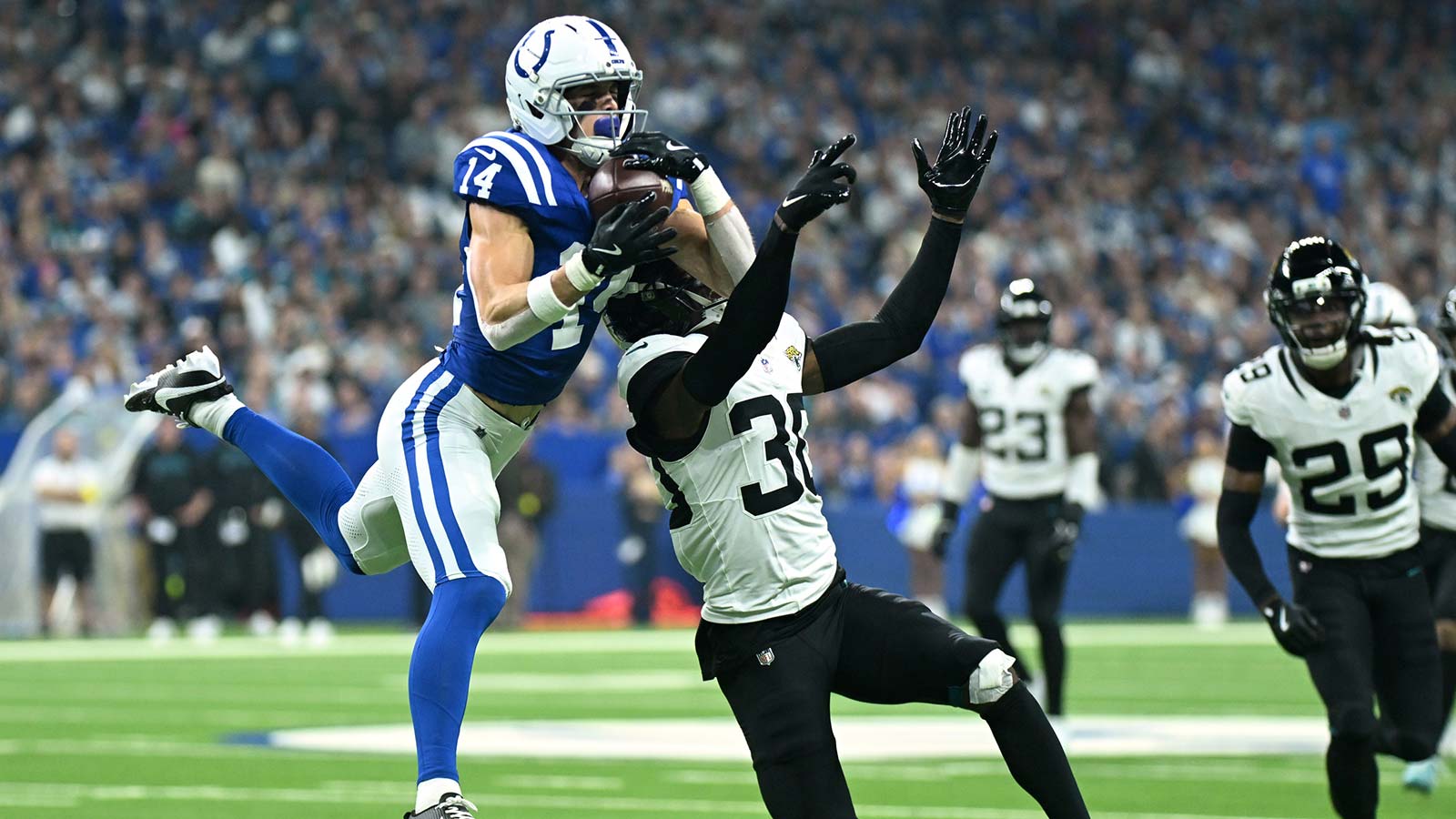 Jacksonville Jaguars cornerback Montaric Brown (30) breaks up a pass intended for Indianapolis Colts wide receiver Alec Pierce (14) during the first half at Lucas Oil Stadium.