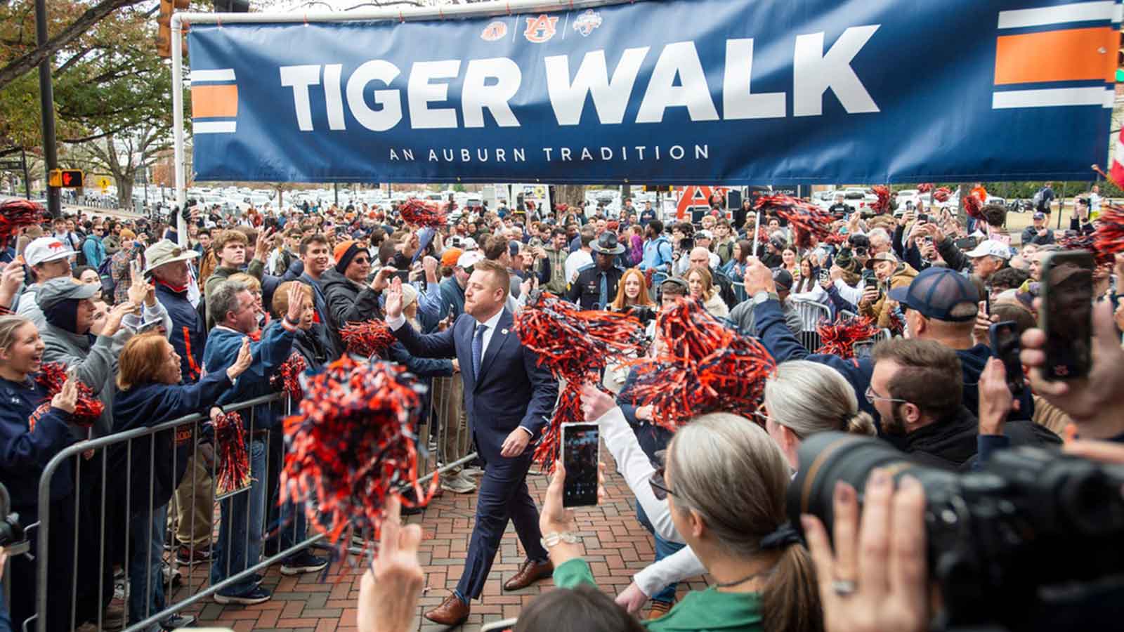 Auburn football head coach Alex Golesh is welcomed during a Tiger Walk at Jordan-Hare Stadium in Auburn, Ala. on Monday, Dec. 1, 2025.