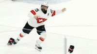 Alina Muller of Switzerland celebrates after scoring the game-winning goal against Sweden during the women's ice hockey bronze medal game during the Milano Cortina 2026 Olympic Winter Games at Milano Santagiulia Ice Hockey Arena.