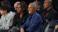 Former first lady Michelle Obama and former President Barack Obama look on before the start of the 75th NBA All Star Game at Intuit Dome.