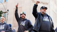 Seattle Seahawks quarterbacks coach Andrew Janocko and offensive line coach John Benton react during the Super Bowl LX parade.
