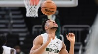 Milwaukee Bucks forward Giannis Antetokounmpo (34) bounces the ball on his head while warming up before game against the Indiana Pacers at Fiserv Forum.