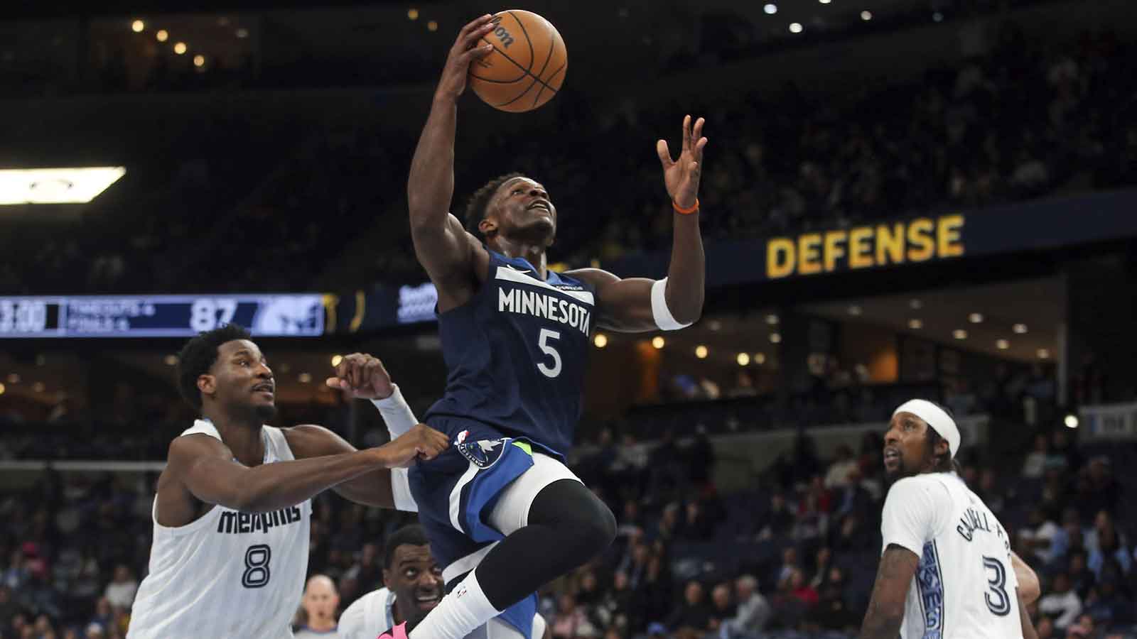 Minnesota Timberwolves guard Anthony Edwards (5) drives to the basket past Memphis Grizzlies forward/center Jaren Jackson Jr. (8) during the fourth quarter at FedExForum.