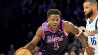 Minnesota Timberwolves guard Anthony Edwards (5) dribbles by Dallas Mavericks forward Caleb Martin (16) in the third quarter at Target Center.