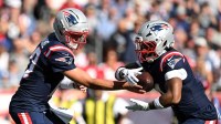 New England Patriots quarterback Drake Maye (10) hands the ball off to running back Antonio Gibson (4) during the second half of a game against the Carolina Panthers at Gillette Stadium.