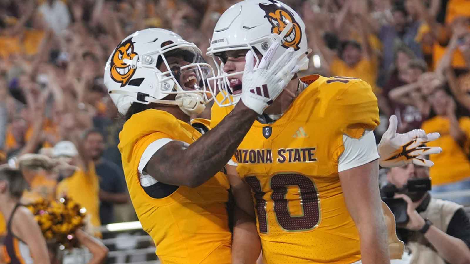 Arizona State quarterback Sam Leavitt (10) celebrates his touchdown run with teammate Jordyn Tyson (0) against the Mississippi State Bulldogs at Mountain America Stadium in Tempe on Sept. 7, 2024.