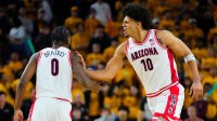 Arizona forward Koa Peat (10) celebrates with guard Jaden Bradley (0) during a game against Arizona State at Desert Financial Arena in Tempe, on Jan. 31, 2026.