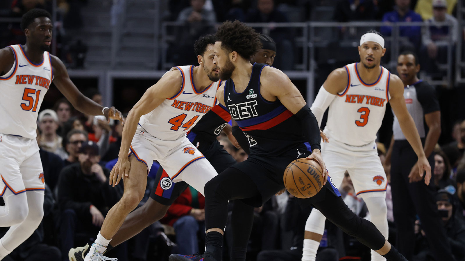 Detroit Pistons guard Cade Cunningham (2) dribbles defended by New York Knicks guard Landry Shamet (44) in the first half at Little Caesars Arena.