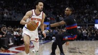 New York Knicks guard Landry Shamet (44) dribbles defended by Detroit Pistons guard Ausar Thompson (9) in the first half at Little Caesars Arena.