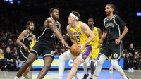 Los Angeles Lakers guard Austin Reaves (15) looks to drive past Brooklyn Nets center Day'ron Sharpe (20) in the fourth quarter at Barclays Center. Mandatory Credit: Wendell Cruz-Imagn Images