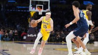 Los Angeles Lakers guard Austin Reaves (15) dribbles the ball against LA Clippers center Yanic Konan Niederhauser (14) in the first half at Crypto.com Arena.