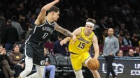 Los Angeles Lakers guard Austin Reaves (15) looks to drive past Brooklyn Nets forward Michael Porter Jr. (17) in the third quarter at Barclays Center.