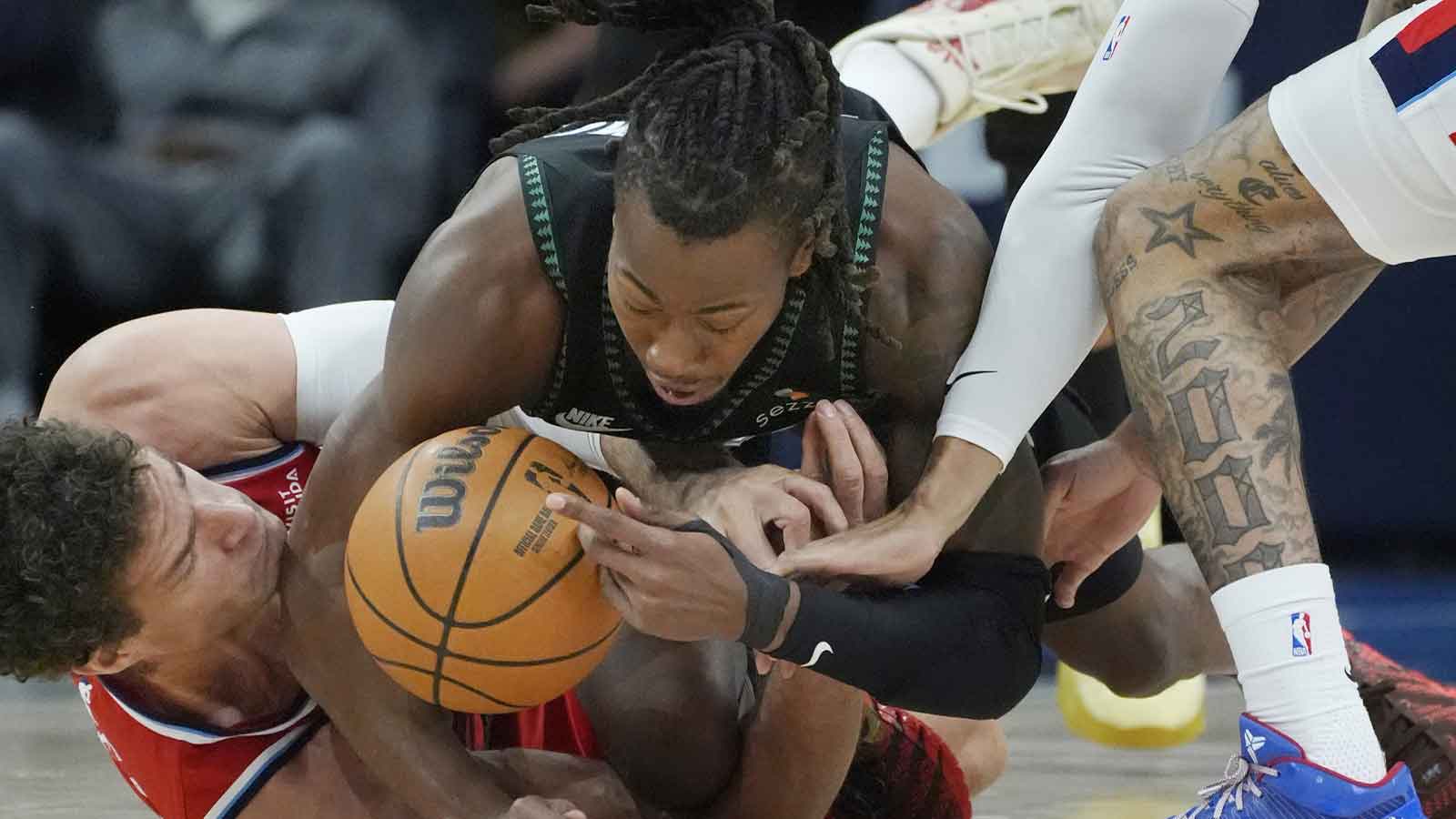 Minnesota Timberwolves guard Ayo Dosunmu (13) battles Los Angeles Clippers center Brook Lopez (11) for the ball in the first quarter at Target Center.
