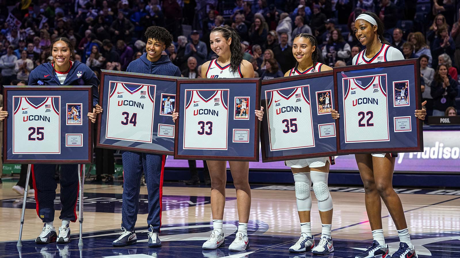 UConn Huskies forward Ice Brady (25), forward Ayanna Patterson (34), guard Caroline Ducharme (33), guard Azzi Fudd (35) and forward Serah Williams (22) hold up their jerseys during senior night after defeating the Providence Friars at Harry A. Gampel Pavilion.