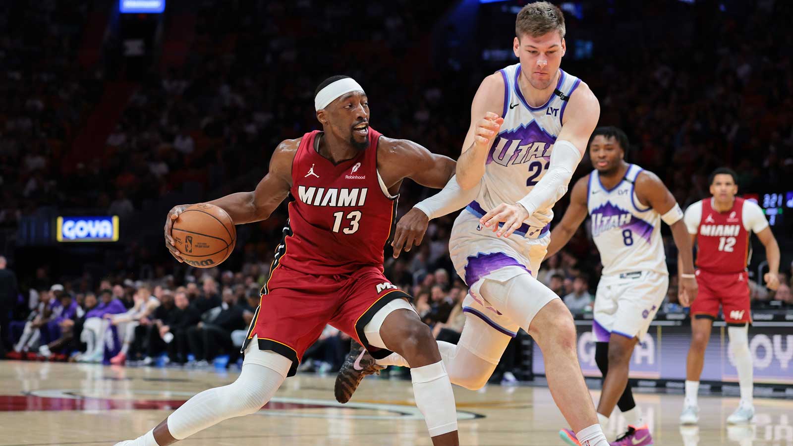 Miami Heat center Bam Adebayo (13) drives to the basket against Utah Jazz forward Kyle Filipowski (22) during the third quarter at Kaseya Center.