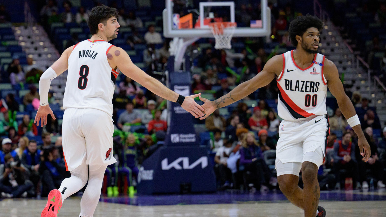 Blazers forward Deni Avdija (8) and Portland Trail Blazers guard Scoot Henderson (00) celebrate during the second half against the New Orleans Pelicans at Smoothie King Center