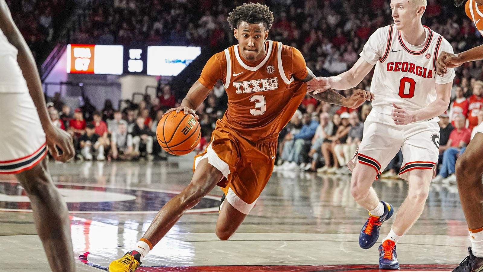 Texas Longhorns forward Dailyn Swain (3) dribbles against Georgia Bulldogs guard Blue Cain (0) at Stegeman Coliseum.