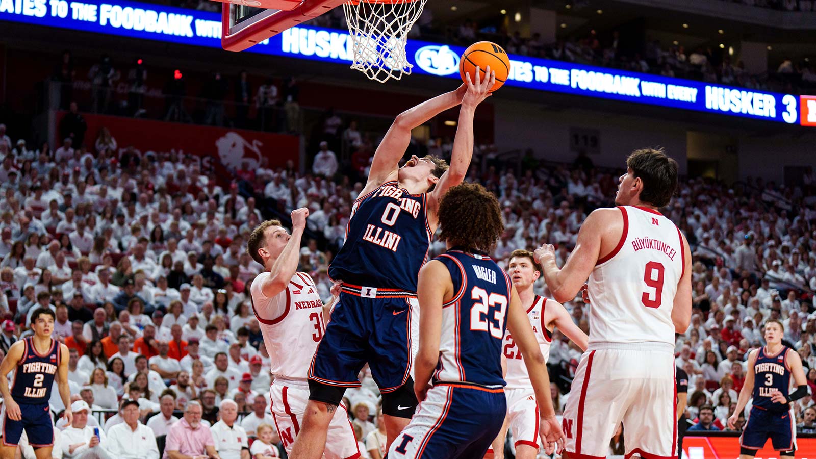 Illinois Fighting Illini forward David Mirkovic (0) shoots the ball against Nebraska Cornhuskers guard Cale Jacobsen (31), forward Pryce Sandfort (21) and forward Berke Buyuktuncel (9) during the second half at Pinnacle Bank Arena.