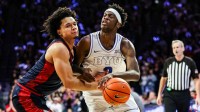 Brigham Young Cougars forward AJ Dybantsa (3) dribbles the ball while Arizona Wildcats guard Brayden Burries (5) attempts to block him during the first half of the game at McKale Memorial Center.