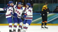 Brock Faber of United States celebrates scoring their third goal with teammates against Germany in men's ice hockey group C play during the Milano Cortina 2026 Olympic Winter Games at Milano Santagiulia Ice Hockey Arena.